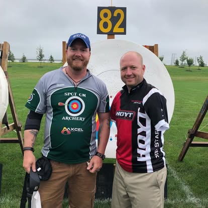 Doug Wright, Society for Archery in Michigan board member, and Matt Stutzman the armless archery standing in front of a archery target