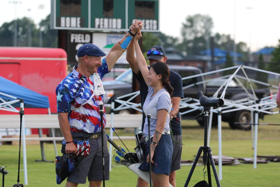 Archers high five at a SAM event